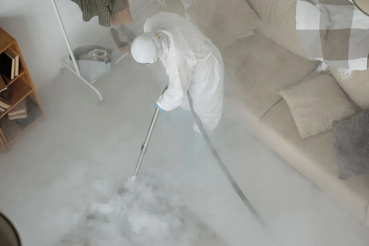 Biohazard cleanup technician in protective equipment, Alice, TX
